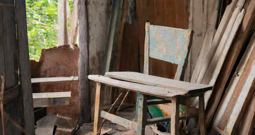 old broken chair in a dusty shed filled with old wood and timber