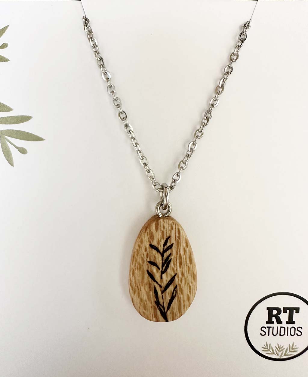 Wooden Silky Oak pendant almond shape with botanical illustration on white background