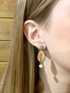 handmade wood and freshwater pearl earrings on an ear model with long brown hair
